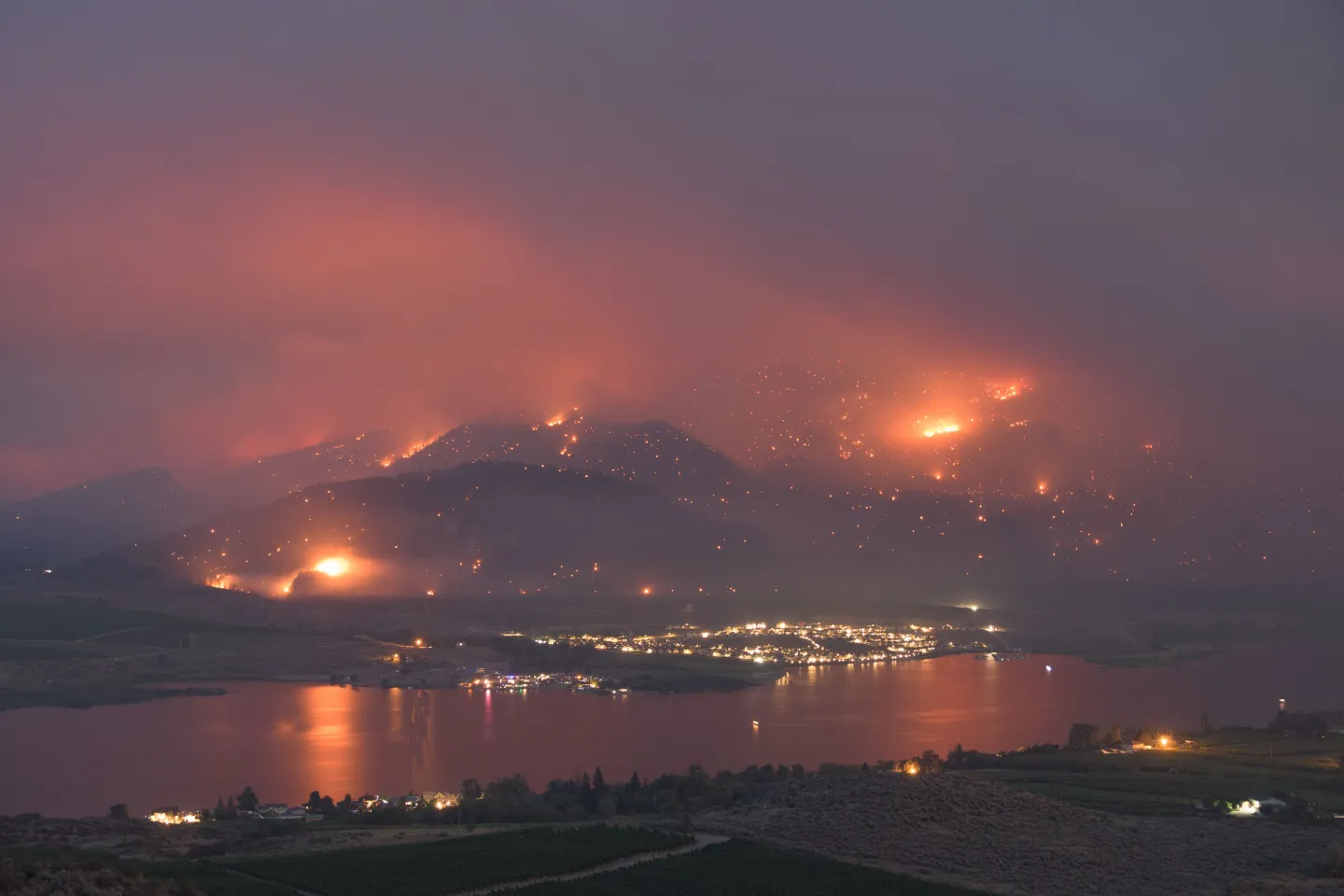 The sky burning orange and yellow with wildfire smoke, the sun reduced to a dull disc.
